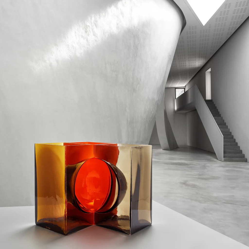 Red glass' design vase in a brutalist intern made of concrete